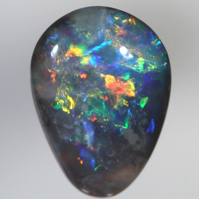 SOLID BLACK OPAL Bright red and orange sparkles over blue